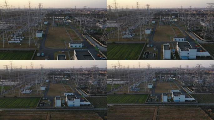 日落时电力塔和大型变电站的实时/鸟瞰图
