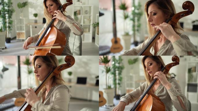 坐在工作室里演奏大提琴的女人