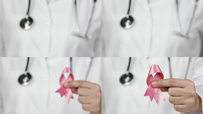 医生向摄像机展示了一条粉红色的乳腺癌意识丝带