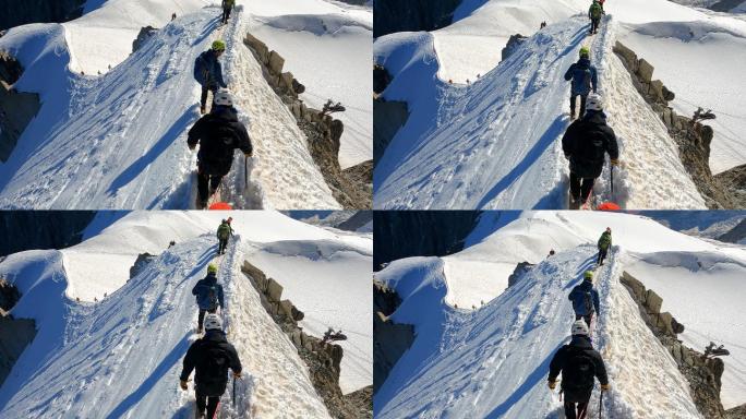 攀登欧洲阿尔卑斯雪峰的登山队。使用绳索和攀爬设备。鸟瞰图