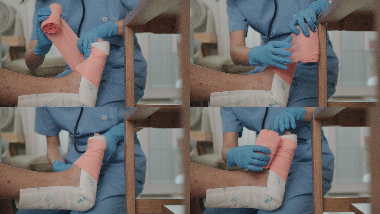 女护士给病人的腿缠上绷带。