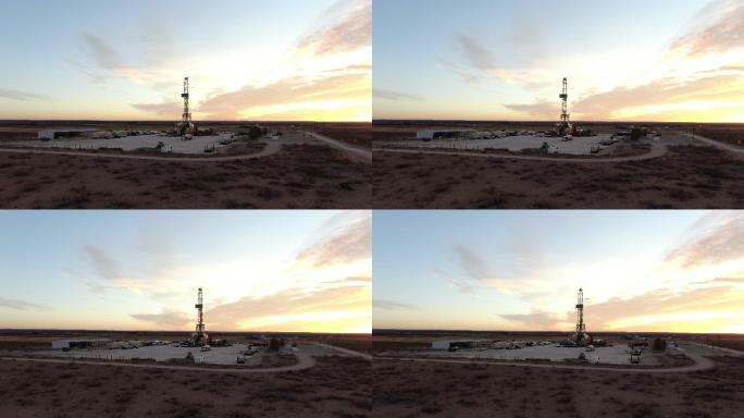 日出时，在美丽的云层覆盖的天空中，无人机俯瞰石油或天然气钻探压裂钻井平台