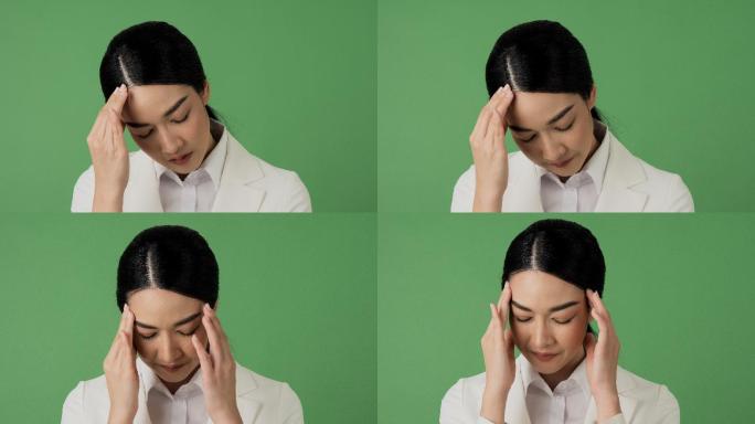 绿色屏幕背景下的亚洲美女肖像。在绿色背景下，特写女性面部感受到压力和疼痛。