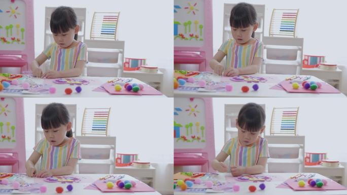 小女孩手工制作蝴蝶纸工艺品供家庭教育使用