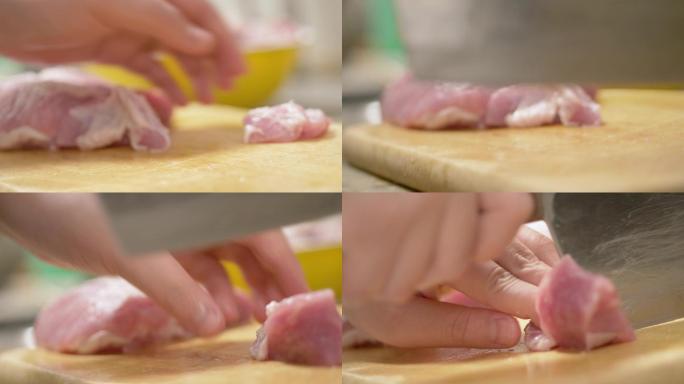 孩子的手在厨房的砧板上切生猪肉在家里，男孩帮助母亲为家人准备食物。