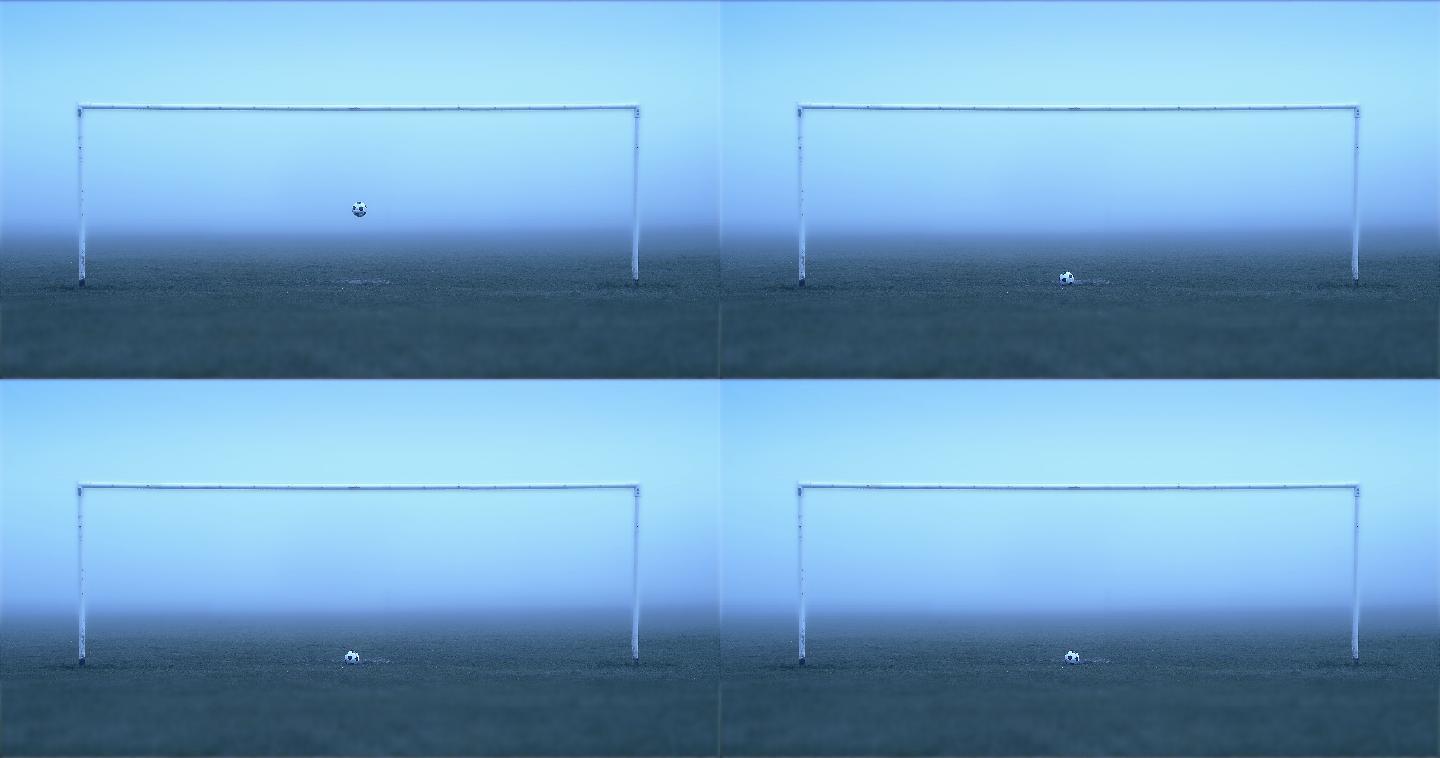 足球在雾气弥漫的空空球门里落下弹跳。