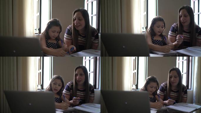 妈妈在家里用笔记本电脑帮助女儿学习
