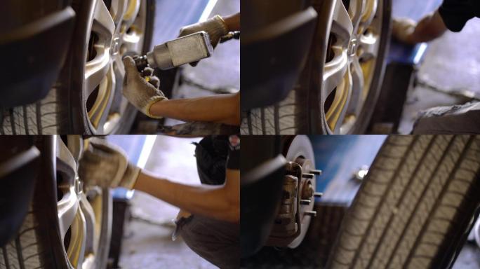 在汽车修理厂更换轮胎的技工