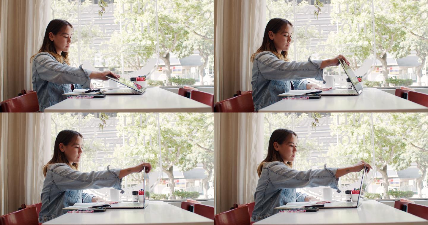 4k视频，一位年轻貌美的女士坐在咖啡馆里使用笔记本电脑