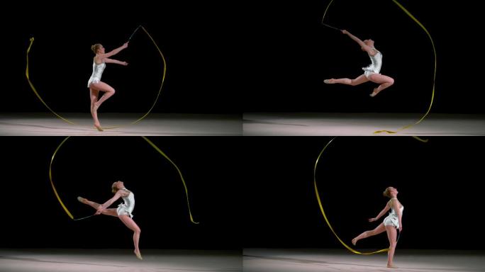 斯洛-莫速度坡道LD艺术体操运动员在空中挥舞着丝带跳跃