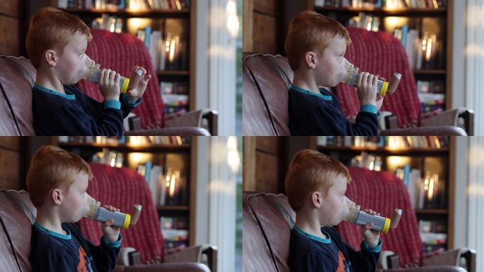 小红发男孩用哮喘吸入器治疗呼吸性哮喘