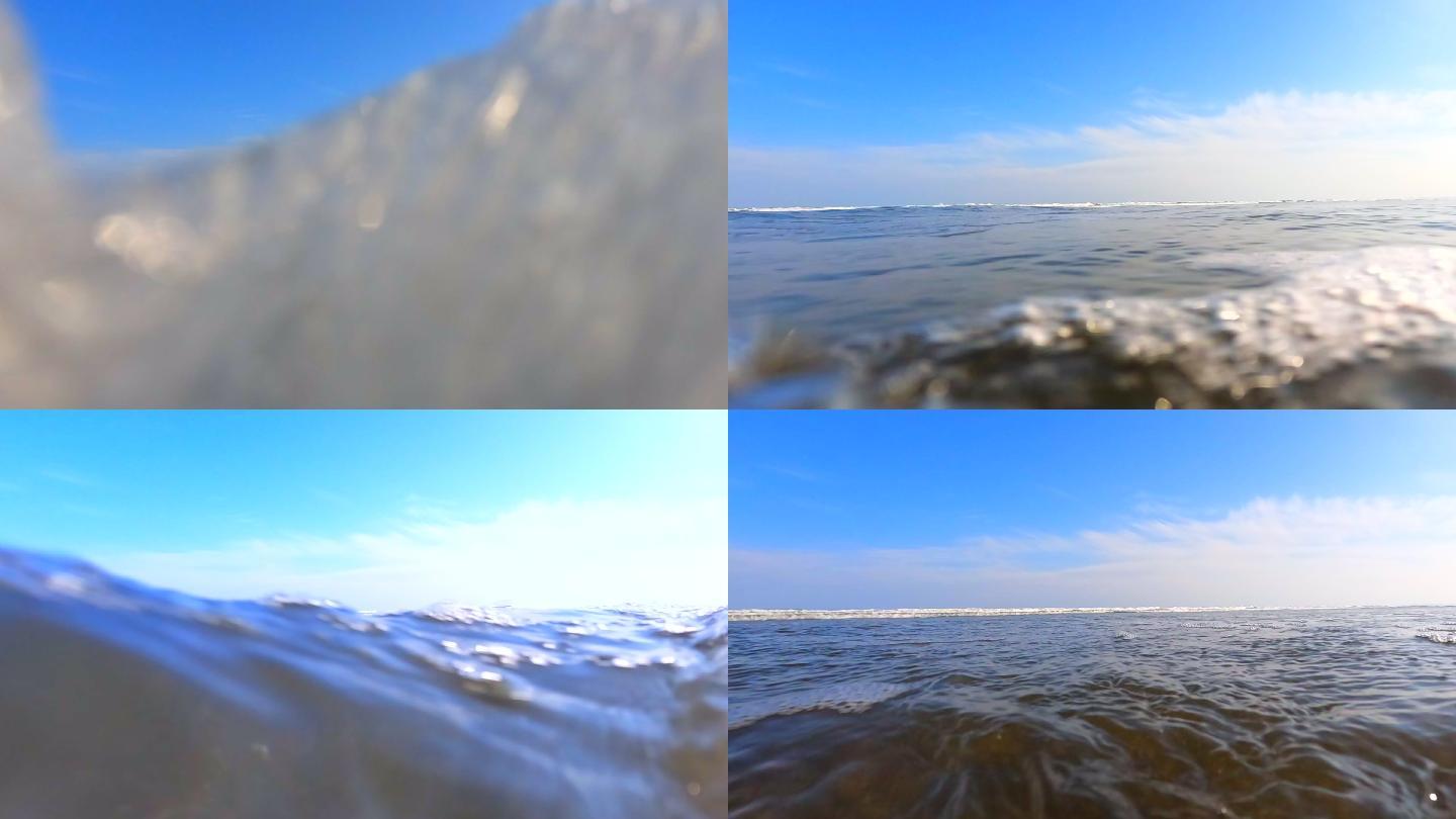 海滩上的浪花。海浪拍打着相机。从低角度拍摄动作摄像机。