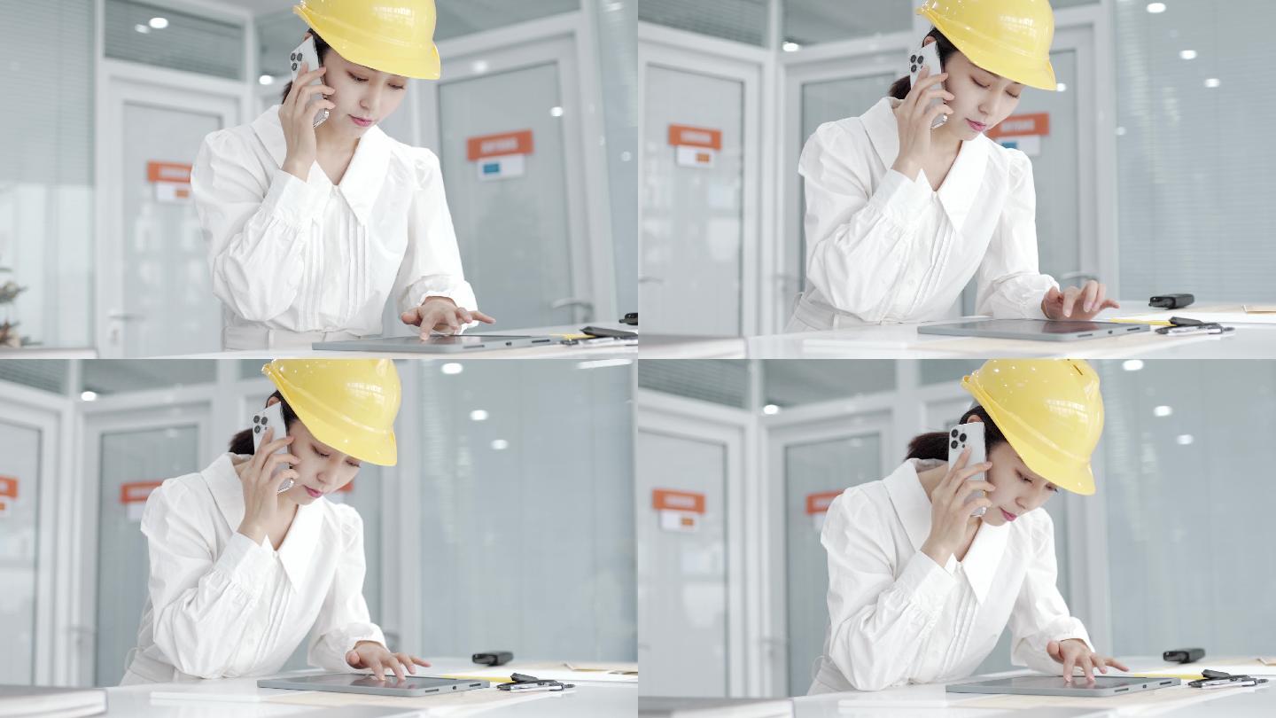 年轻漂亮的亚洲女工程师，戴着黄色头盔，使用平板电脑设计