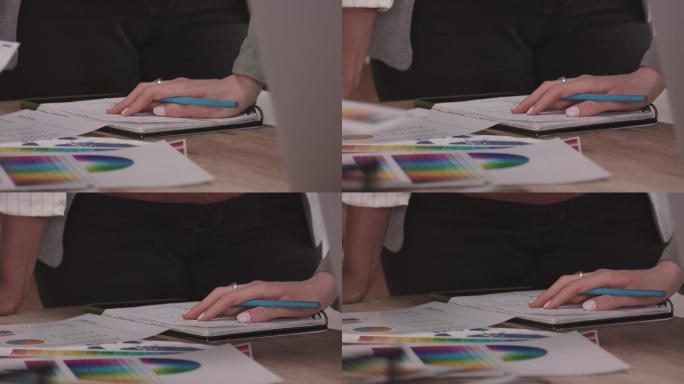 不知名的女性设计专业人士在一次会议上查看颜色图表