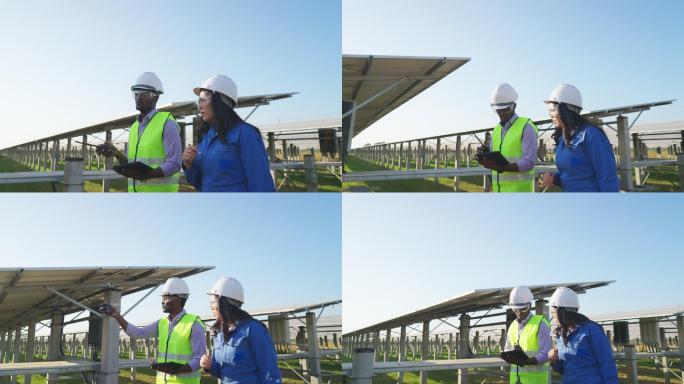 身穿蓝色防护服的亚洲中年女性技术员和穿着反光布的非洲工程师一起工作，使用数字平板电脑检查太阳能发电场