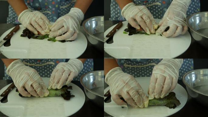 亚洲女性在厨房制作蔬菜沙拉卷，家居行业理念