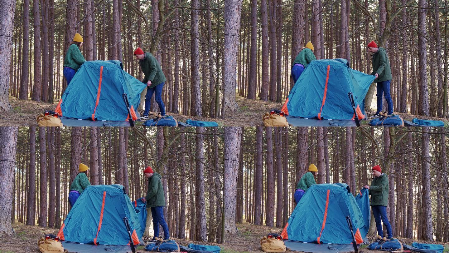 年轻的异性恋情侣搭起帐篷露营