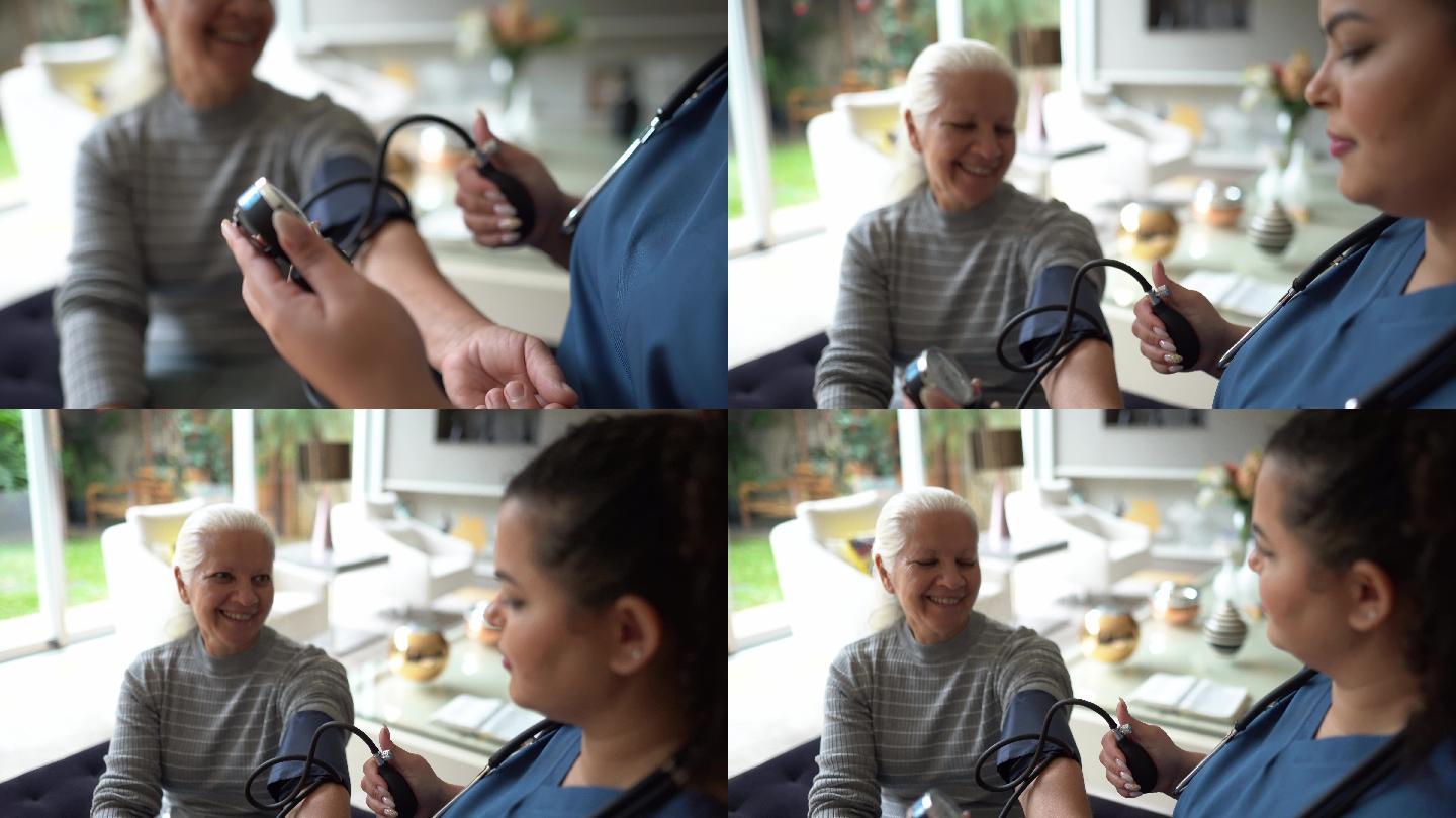 护士在家给一位老年患者量血压