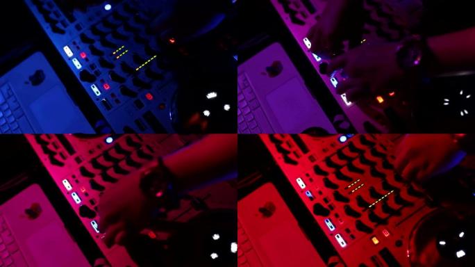 DJ的手在DJ的甲板上调整各种轨道控制，摄像机正在呼吸