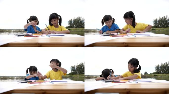 兄弟姐妹用彩色铅笔在纸上画卡通的场景，教育背景