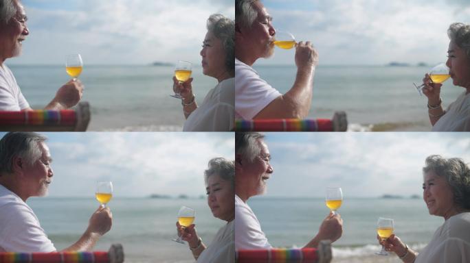 老年夫妇在海边喝着饮料放松