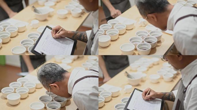 high angle view专业亚裔中国咖啡师分级员在品尝咖啡杯后在剪贴板上记录咖啡杯