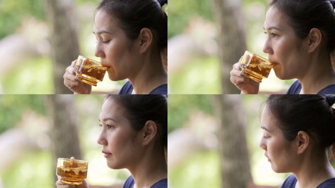 CS 4K亚洲女人喝着热樱花花茶。