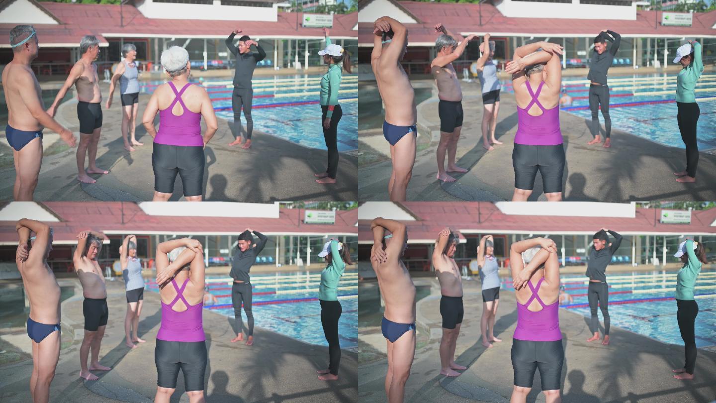 亚裔中国游泳教练在泳池边教高年级学生游泳课前的热身运动