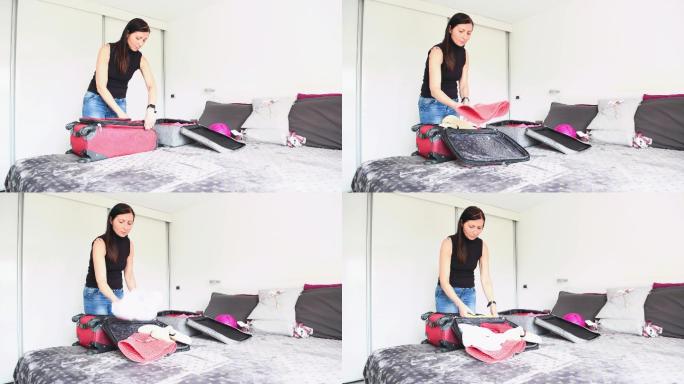 打开行李准备旅行。一个女人从旅行归来的行李箱中打开衣服的特写镜头。