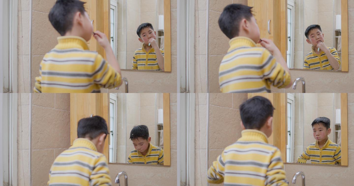 小男孩对着镜子刷牙