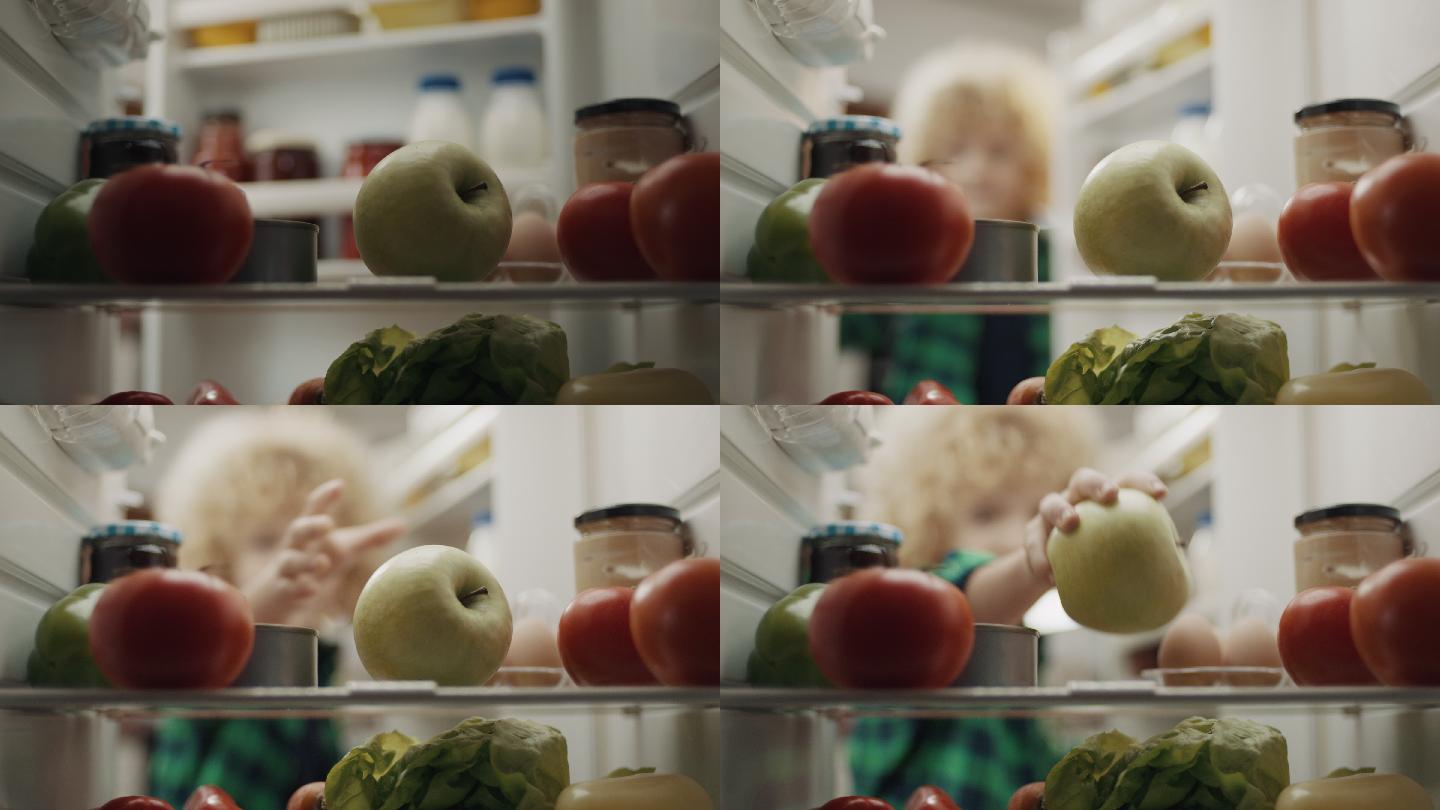 男孩从冰箱里拿苹果！