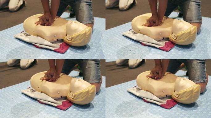 4K慢动作：心肺复苏培训班演示在假人上抽水、急救或医疗概念。