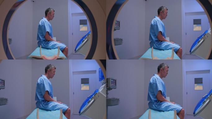 DS男子坐在MRI扫描仪的桌子上等待医生