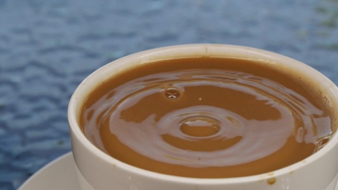 牛奶咖啡杯中水滴下落的慢运动