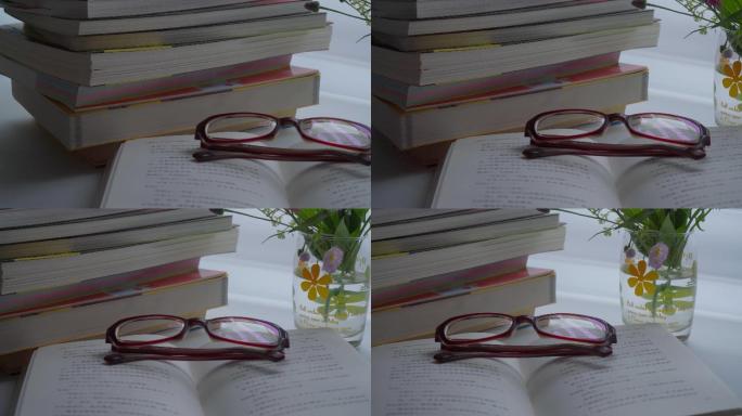 窗边书桌眼镜折叠一堆树花高考