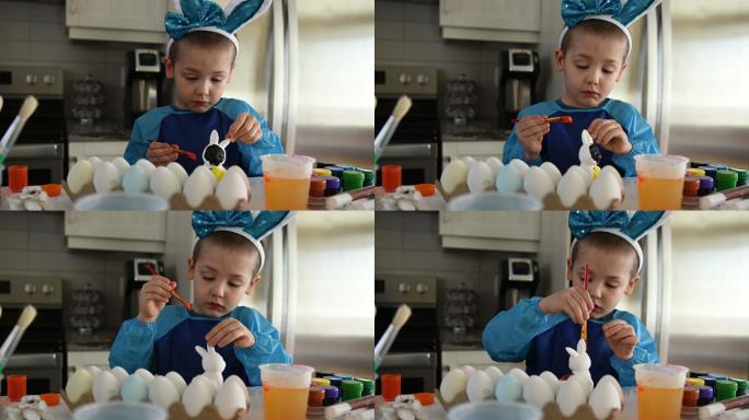 孩子们在家的厨房里装饰复活节彩蛋