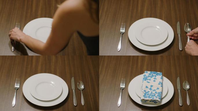 一位白人妇女将叉子、刀和勺子放在白色餐盘两侧的木桌上，上面有一个白色沙拉盘，然后在盘子上放上一块彩色