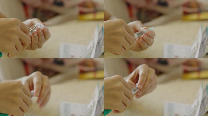亚洲女性使用预充式笔式注射器注射FSH