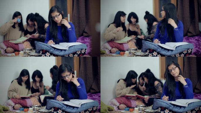 勤奋好学的年轻女子试图在吵闹的宿舍里学习。