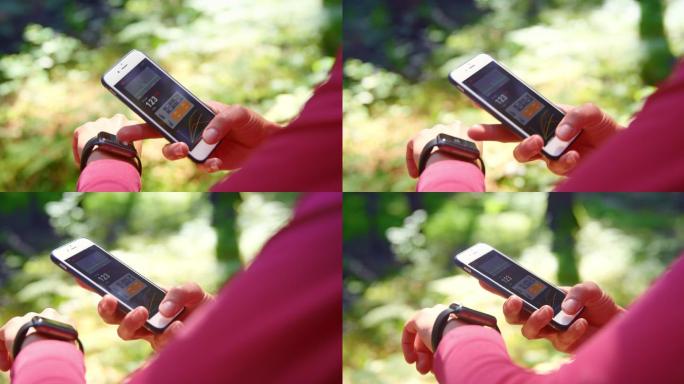 SLO MO女跑步者查看手表和智能手机上的数据