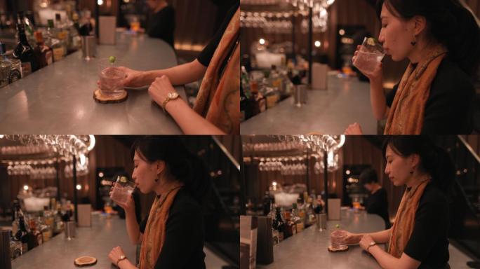 亚洲女性在豪华酒吧喝鸡尾酒