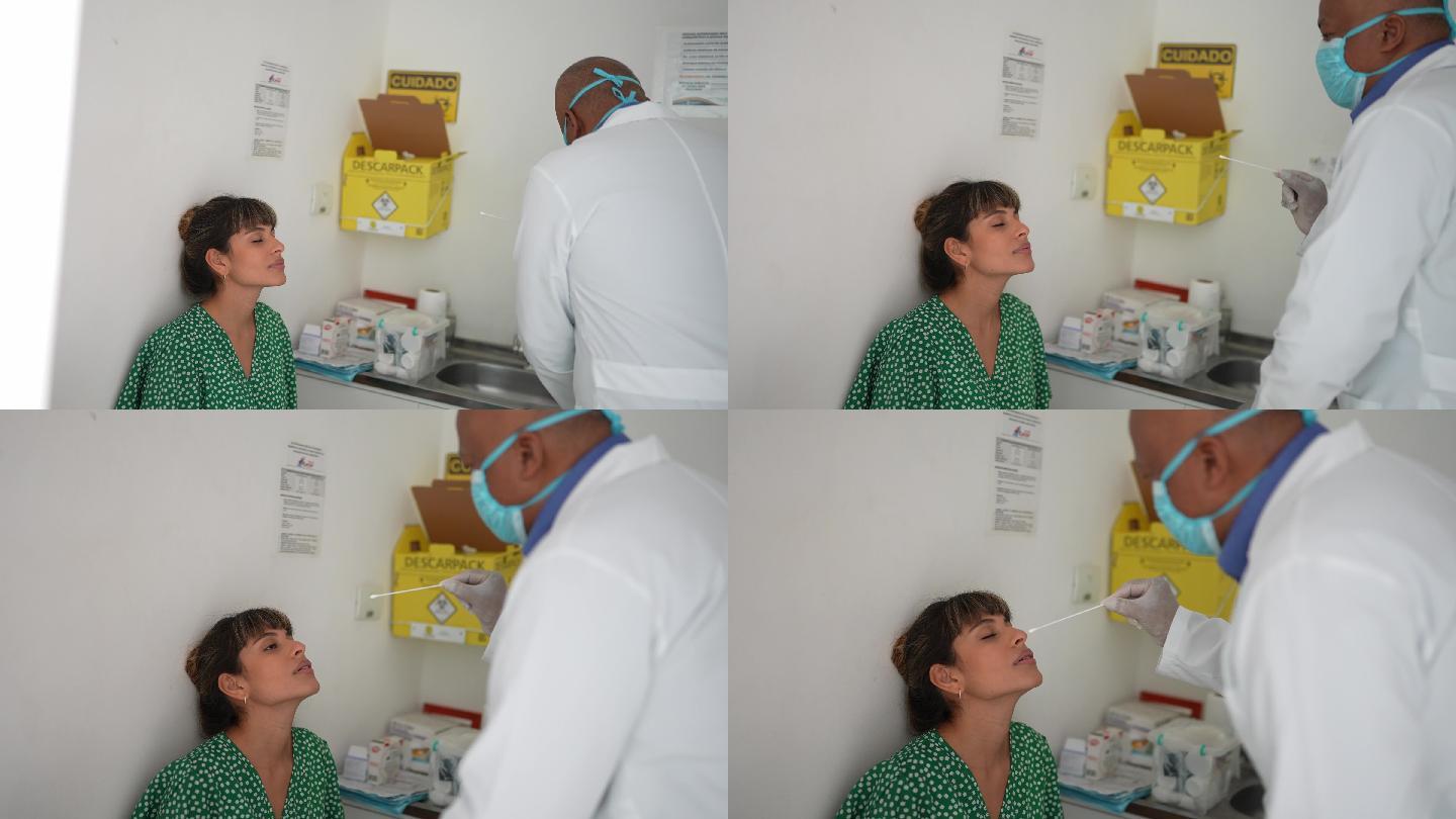 护士在药房对一名年轻女子进行鼻拭子测试