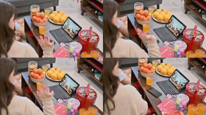 快乐的亚洲家庭在家里通过数字平板电脑上的视频通话在线迎接中国新年，并与亲戚团聚