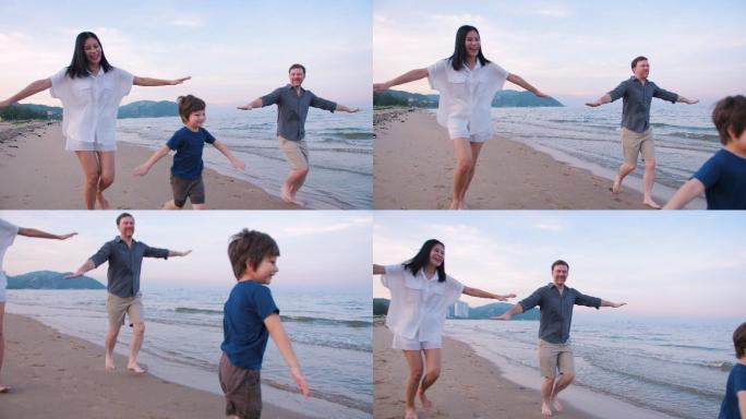 周末，幸福的一家人在海滩散步和跑步。