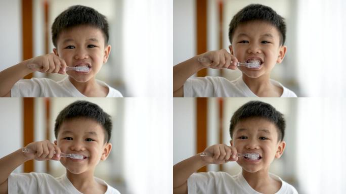 亚洲小孩在浴室刷牙。日常健康和牙科护理的概念