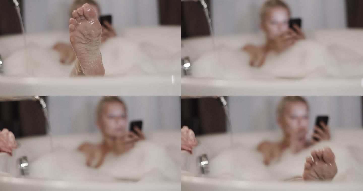 斯洛·莫（SLO MO）在泡泡浴时使用手机