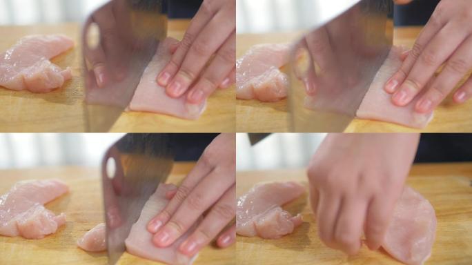 用手在砧板上切鸡肉，慢动作。