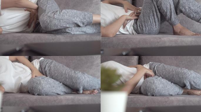 亚洲女性在家躺在沙发上时腹痛