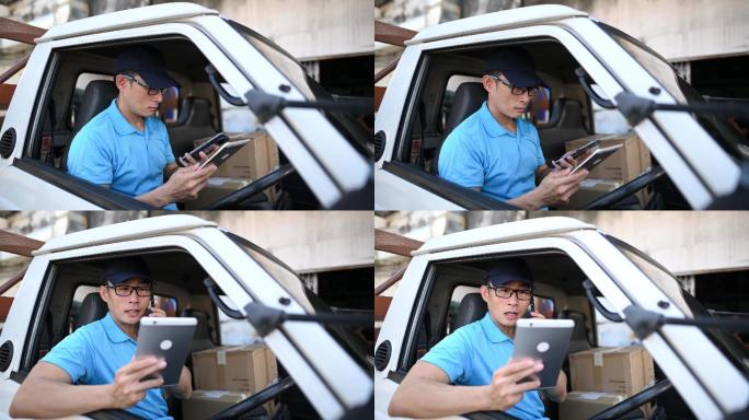 亚裔中国成年男性送货员使用数字平板电脑移动应用程序检查送货车司机座位上的送货信息