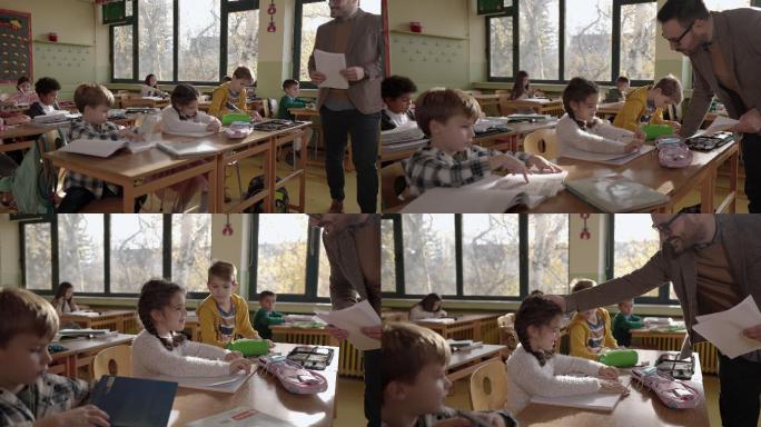 快乐的老师在小学帮助他的学生上课。